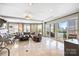 Bright, open living room with marble floors, large windows, and access to outdoor balcony at 520 E Martin Luther King Jr Blvd # 1002, Charlotte, NC 28202