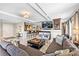 Open-concept living room featuring tile floors, a fireplace with tv and access to kitchen at 520 E Martin Luther King Jr Blvd # 1002, Charlotte, NC 28202