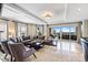 Open-concept living room with gray furnishings, large windows, and access to outdoor balcony at 520 E Martin Luther King Jr Blvd # 1002, Charlotte, NC 28202
