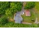 A high angle view of the home highlighting the detached garage, brick and gray roof at 648 Odell School Rd, Concord, NC 28027