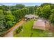 Beautiful property with brick home, spacious yard, detached garage, and long driveway at 648 Odell School Rd, Concord, NC 28027