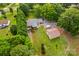 Expansive aerial view of property showing brick home, detached garage, and mature landscaping at 648 Odell School Rd, Concord, NC 28027