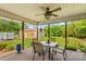 A shaded outdoor patio space with a dining table and chairs overlooking a spacious backyard at 648 Odell School Rd, Concord, NC 28027