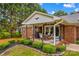 Backyard patio with an outdoor dining set, grill, and decorative landscaping at 648 Odell School Rd, Concord, NC 28027