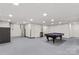 Spacious basement area with pool table and storage at 648 Odell School Rd, Concord, NC 28027