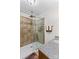 Bathroom with tile shower, glass door, and granite countertop at 648 Odell School Rd, Concord, NC 28027