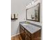 Bathroom with granite countertops, a decorative mirror, and a shower with tile surround at 648 Odell School Rd, Concord, NC 28027
