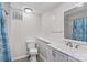 Bathroom with a white vanity, toilet, and a shower with nautical themed curtain at 648 Odell School Rd, Concord, NC 28027