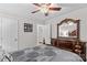 Bedroom featuring a wooden dresser and an ornamental mirror, carpeted floor, ceiling fan at 648 Odell School Rd, Concord, NC 28027