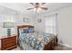 Comfortable bedroom with floral bedding, a ceiling fan, and a window with curtains at 648 Odell School Rd, Concord, NC 28027