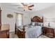 Bedroom features a wooden bed frame, a ceiling fan, and a window with natural light at 648 Odell School Rd, Concord, NC 28027