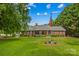 Brick home with manicured lawn, American flag and lush green trees at 648 Odell School Rd, Concord, NC 28027