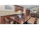 Spacious kitchen area with brown cabinets, stainless appliances, and an adjacent living space at 648 Odell School Rd, Concord, NC 28027