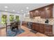 Kitchen with dark cabinets, stainless steel appliances, and a dining table under recessed lighting at 648 Odell School Rd, Concord, NC 28027