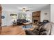 Cozy living room with hardwood floors, a brick fireplace, and leather sofas at 648 Odell School Rd, Concord, NC 28027