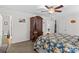 The spacious main bedroom featuring an ornate bedframe, carpeted flooring and matching wardrobe at 648 Odell School Rd, Concord, NC 28027