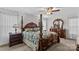 Spacious main bedroom featuring a beautiful canopy bed, matching nightstands and dresser at 648 Odell School Rd, Concord, NC 28027
