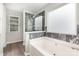 Bathroom with modern tub, marble shower and natural light at 6608 Pattonsburg Dr, Charlotte, NC 28213