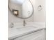 Close-up of a modern bathroom with a stylish round mirror and a sleek white countertop at 6608 Pattonsburg Dr, Charlotte, NC 28213