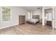 Well-lit bedroom with a rustic-style bed frame and a matching dresser, enhanced by natural light at 6608 Pattonsburg Dr, Charlotte, NC 28213
