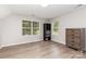 Bright bedroom with a dresser and a bookshelf, featuring two windows that offer natural light at 6608 Pattonsburg Dr, Charlotte, NC 28213