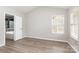Bedroom with hardwood floors, a window, neutral walls and a door leading into the bathroom at 6608 Pattonsburg Dr, Charlotte, NC 28213