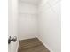 Walk-in closet with new shelving, fresh paint and hardwood floors at 6608 Pattonsburg Dr, Charlotte, NC 28213