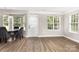 Dining area with a marble-topped table, gray chairs, and ample natural light from windows at 6608 Pattonsburg Dr, Charlotte, NC 28213