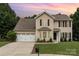 Charming two-story home featuring neutral siding, black shutters, and a well-manicured lawn at 6608 Pattonsburg Dr, Charlotte, NC 28213