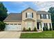 Charming two-story home with a well-manicured lawn and attached two-car garage at 6608 Pattonsburg Dr, Charlotte, NC 28213