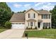 Charming two-story home featuring neutral siding, black shutters, and a well-manicured lawn at 6608 Pattonsburg Dr, Charlotte, NC 28213