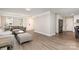 Bright, open-concept space with modern gray furniture and wood flooring throughout the living area at 6608 Pattonsburg Dr, Charlotte, NC 28213