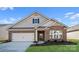 Charming single-story home with brick accents, a two-car garage, and well-maintained landscaping at 674 Georgie St, Troutman, NC 28166