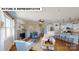 Bright living area with a stone fireplace, hardwood flooring, and an open layout connecting to the kitchen at 674 Georgie St, Troutman, NC 28166