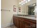 Bathroom showcasing granite countertops, dark wood cabinets, and an oversized vanity mirror at 6742 Charlotte Hwy, York, SC 29745
