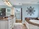Elegant bathroom with marble countertops, custom cabinetry and separate tub at 6742 Charlotte Hwy, York, SC 29745