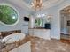 Spacious bathroom with a soaking tub, chandelier, and large oval window at 6742 Charlotte Hwy, York, SC 29745