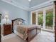 Bedroom with tray ceiling, a queen bed, and glass french doors opening to a patio at 6742 Charlotte Hwy, York, SC 29745