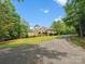 Beautiful exterior shot of home and manicured lawn with blue skies and scattered trees at 6742 Charlotte Hwy, York, SC 29745