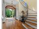 Open foyer featuring hardwood floors, a curved staircase, and elegant lighting at 6742 Charlotte Hwy, York, SC 29745