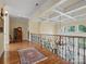 Upper hallway featuring hardwood floors, coffered ceiling, and wrought iron railing at 6742 Charlotte Hwy, York, SC 29745