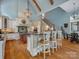 Bright kitchen boasts custom cabinets, wooden floors, granite countertops, and a large island with bar seating at 6742 Charlotte Hwy, York, SC 29745