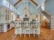 Bright kitchen with soaring ceilings, chandeliers, barstool seating and an open staircase at 6742 Charlotte Hwy, York, SC 29745
