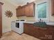 Laundry room with sink, washer, dryer, and wooden cabinets at 6742 Charlotte Hwy, York, SC 29745