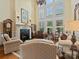 Spacious living room with a fireplace, large windows, and comfortable seating at 6742 Charlotte Hwy, York, SC 29745