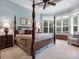 Bright main bedroom with tray ceilings, plantation shutters, and a four-poster bed at 6742 Charlotte Hwy, York, SC 29745