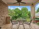 Outdoor patio with metal table and chairs and an outdoor view of green trees at 6742 Charlotte Hwy, York, SC 29745