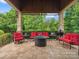 Covered outdoor patio with a tile floor, a firepit and outdoor seating at 6742 Charlotte Hwy, York, SC 29745