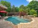 Beautiful backyard pool with stone waterfall, lounge area and lush landscaping for a private retreat at 6742 Charlotte Hwy, York, SC 29745