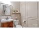 Charming powder room showcases classic design elements with a decorative mirror, wall paper and elegant fixtures at 8301 Caesars Head Dr, Waxhaw, NC 28173